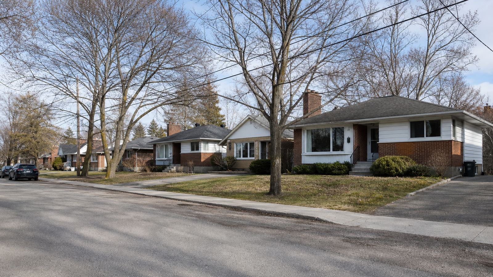 A residential street of older Ottawa homes on a clear day